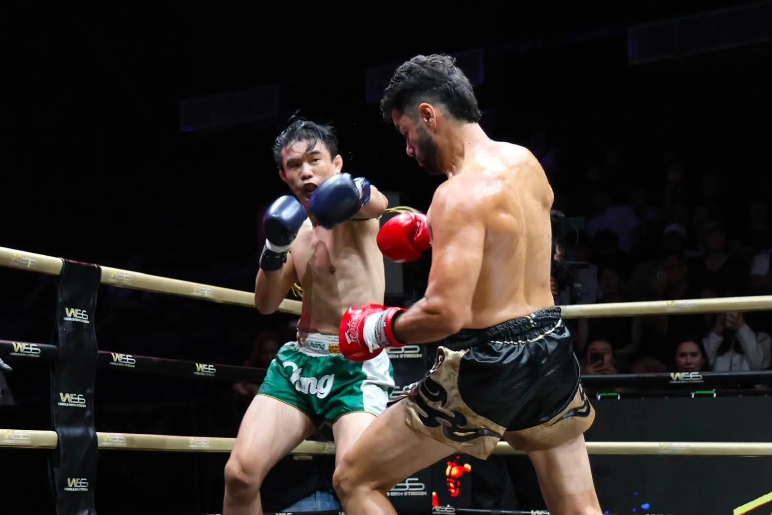 Two Muay Thai fighters trade punches at close range