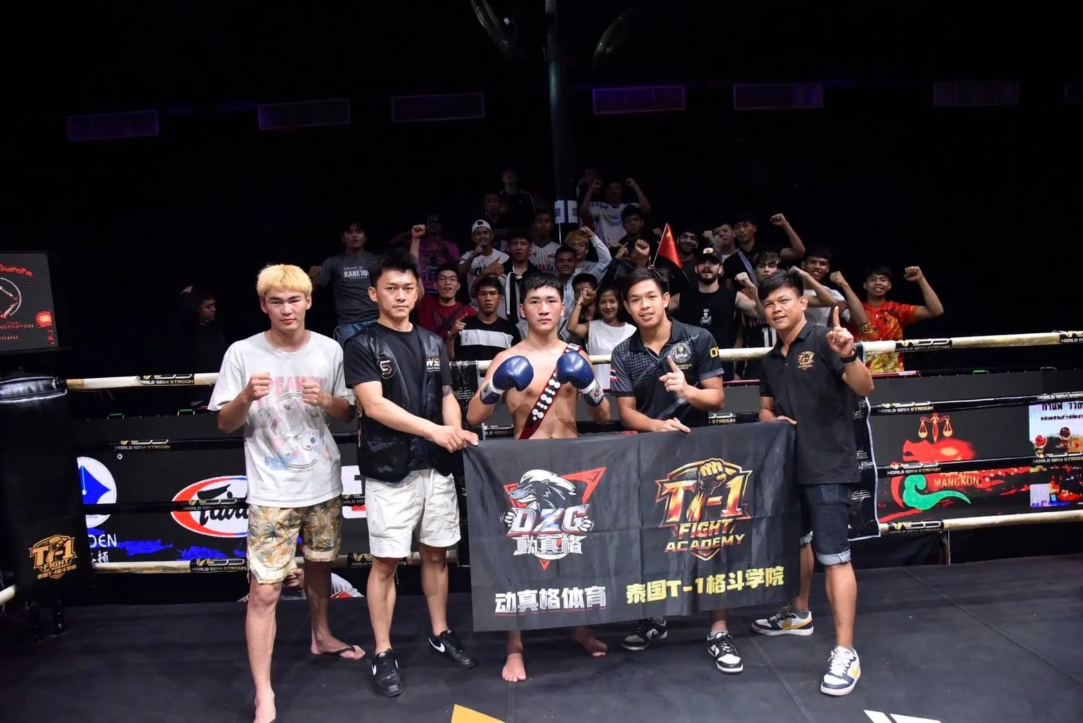 A fighter and his team pose together in the SRC ring