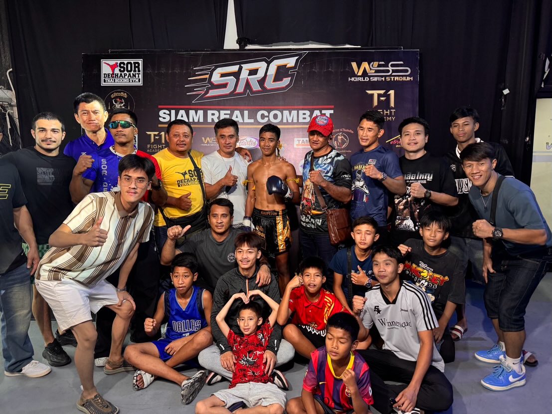 Fighters and supporters gather beneath the Siam Real Combat banner
