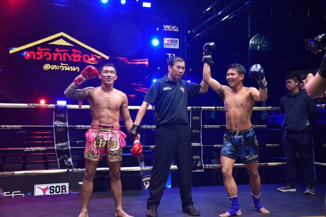 A referee raises a fighter’s hand at Siam Real Combat