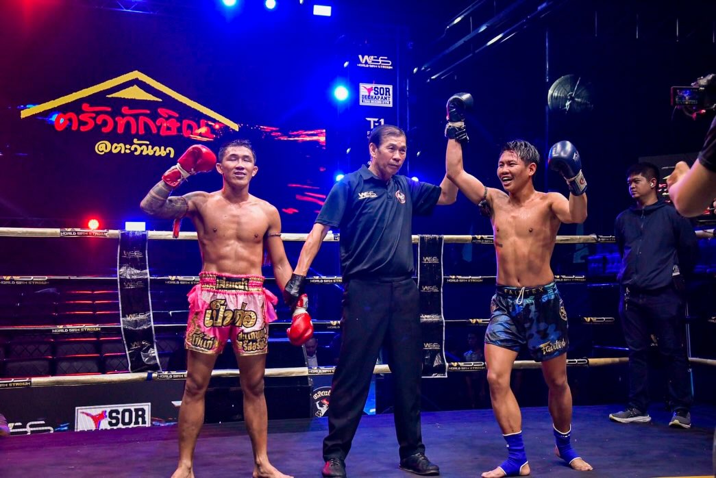 A Fairtex fighter celebrating a victory in the ring